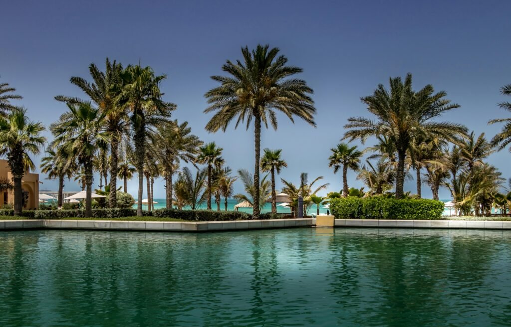 Tranquil resort with palm trees and pool overlooking the beach in Dubai