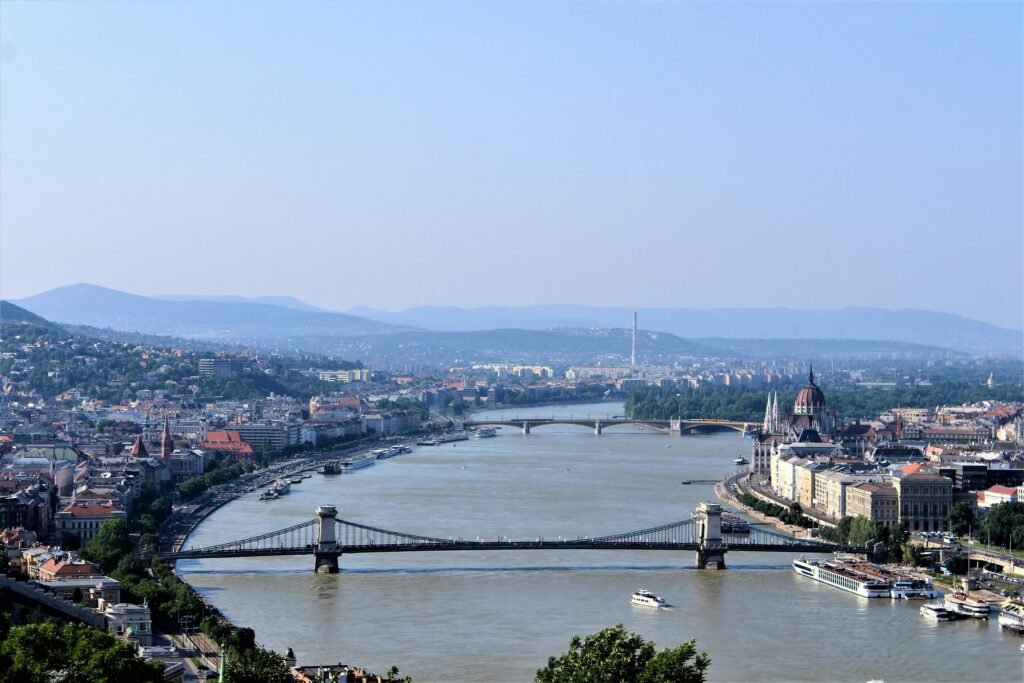 Breathtaking aerial view of Budapest with Chain Bridge and Danube River, showcasing urban beauty and architectural landmarks.