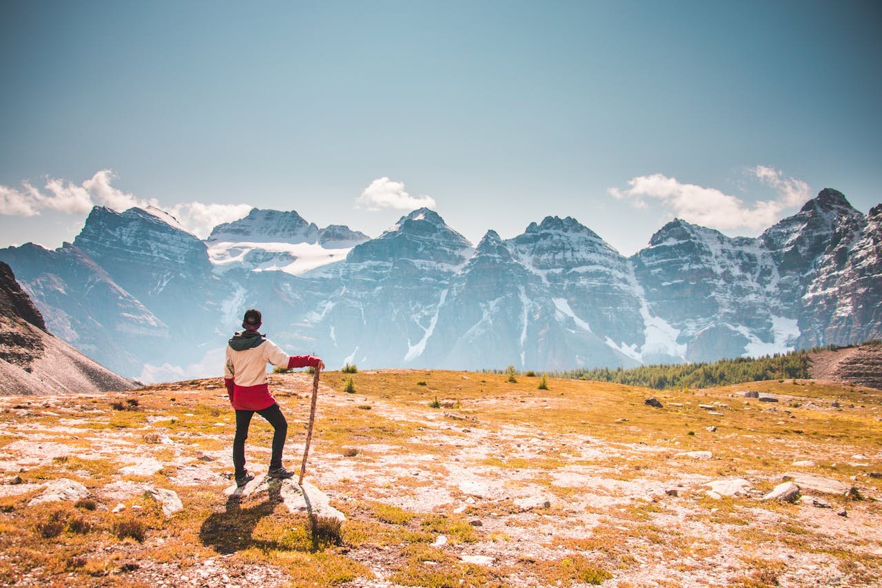 Hiker with a stick overlooking the beautiful Canadian Rockies in Banff National Park.