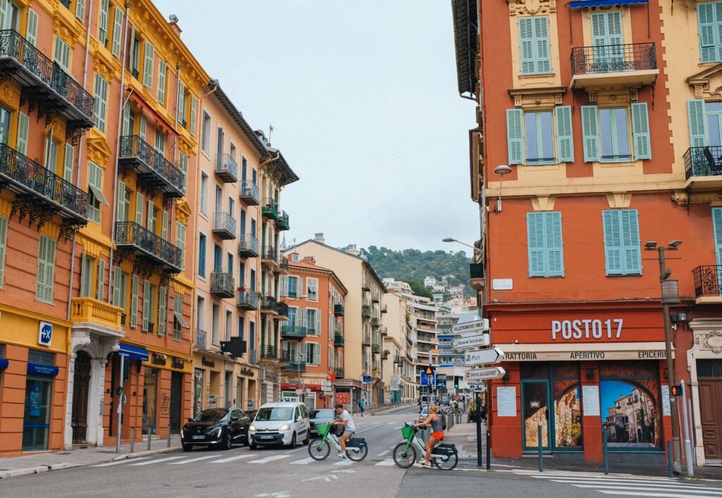 A vibrant urban street scene in Nice featuring cyclists and Perfect for travel and lifestyle themes.