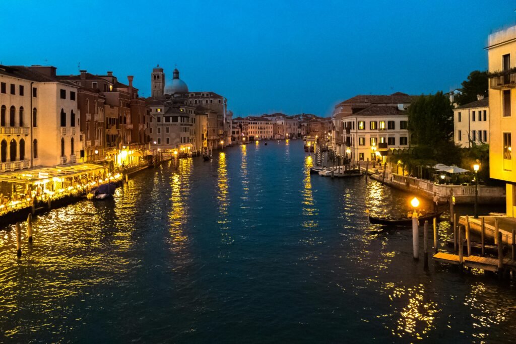Stunning view of Venice's Grand Canal illuminated at night, capturing the historic architecture and vibrant atmosphere.