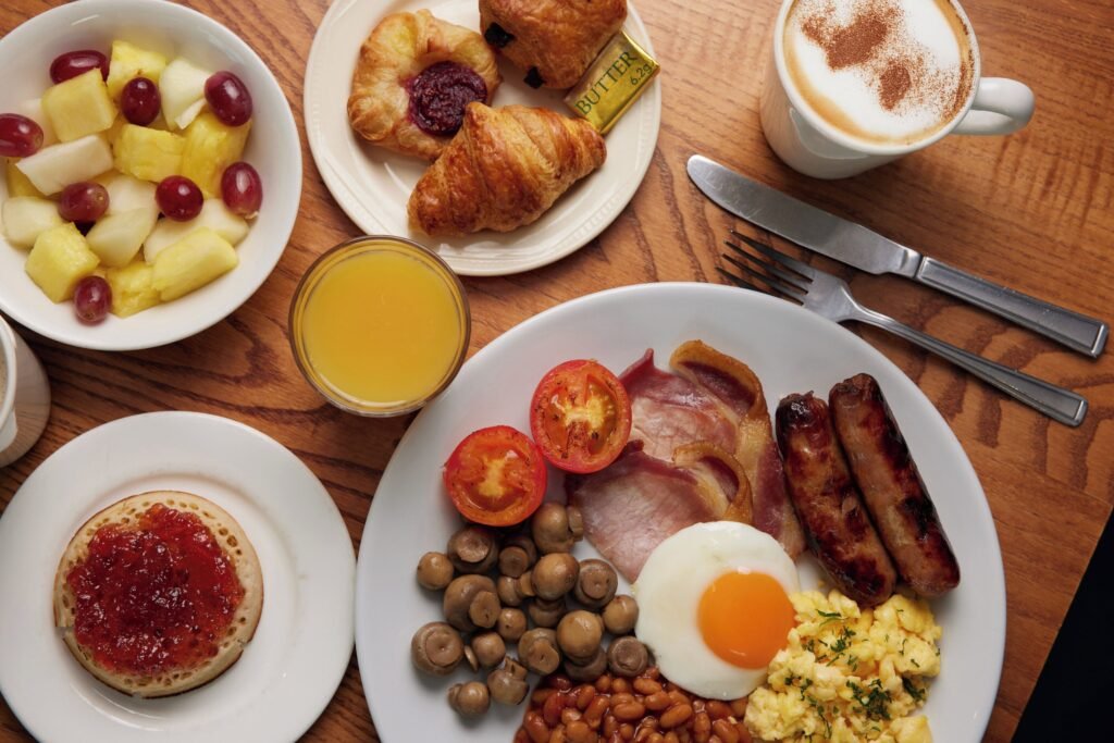 Full English breakfast with pastries and fruit in Thistle London Heatrow airport
