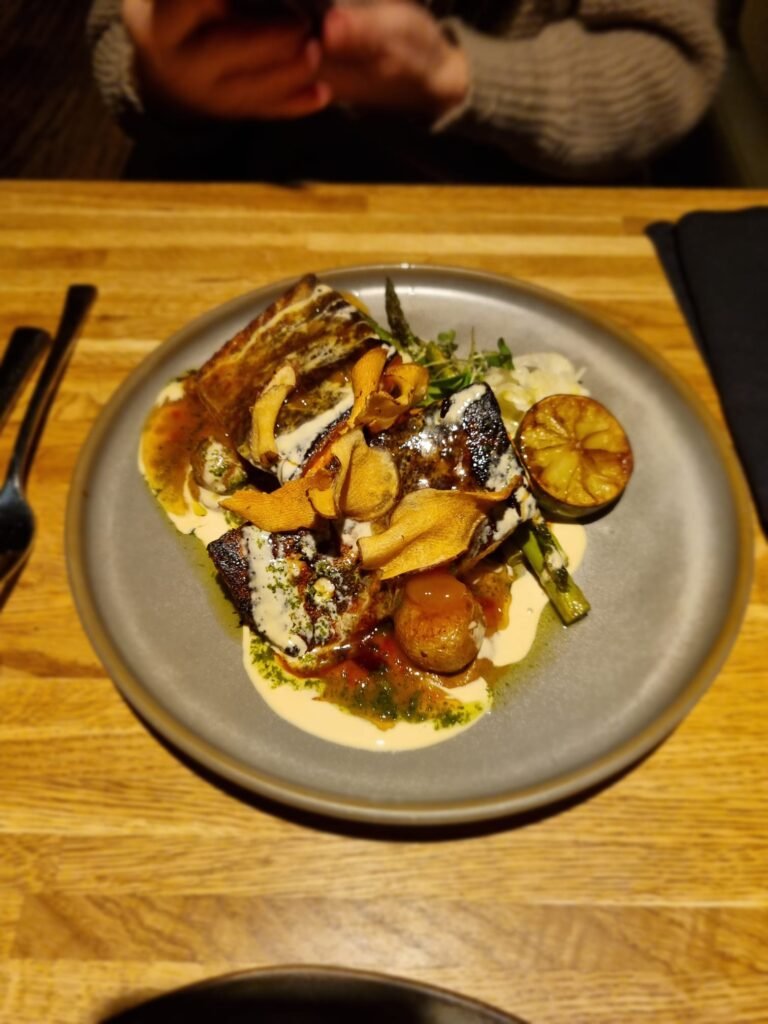 Gourmet dish with vegetables and sauce in Rub 23 Akureyri