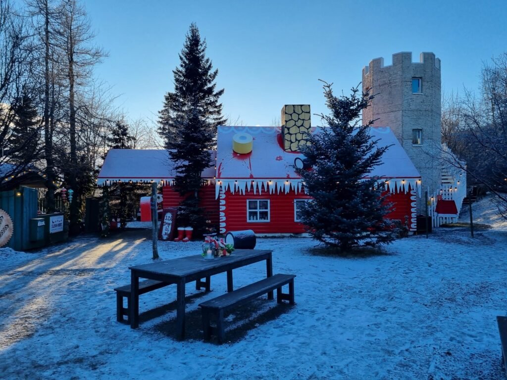 Colourful cabin in snowy landscape in Christmas house, Akureyri.