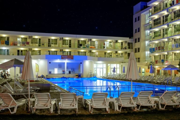 Sunny Beach hotel Illuminated poolside at night.