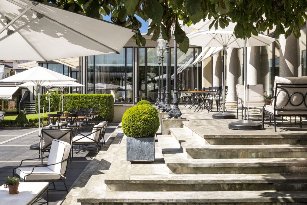 Stylish outdoor seating area with greenery in Swizerland