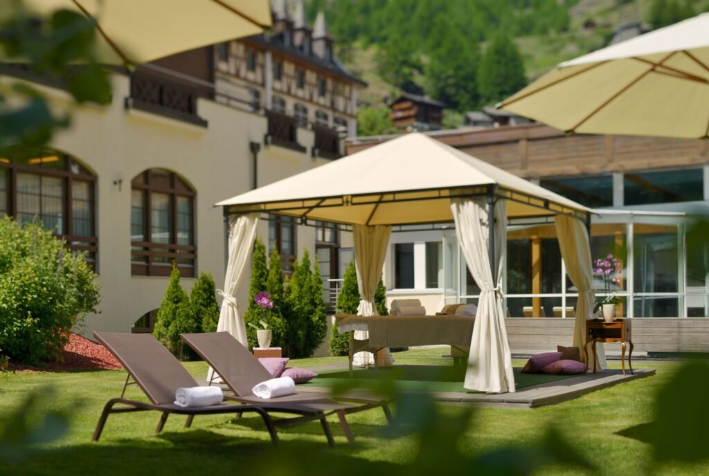 Elegant garden with sun loungers and gazebo in Zermatt
