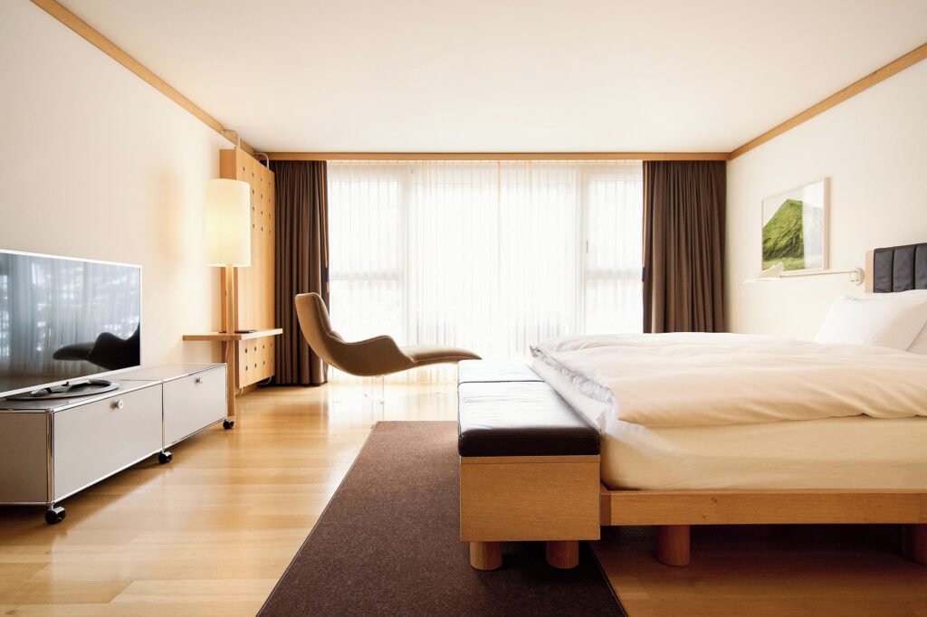 Modern, minimalist hotel room interior.