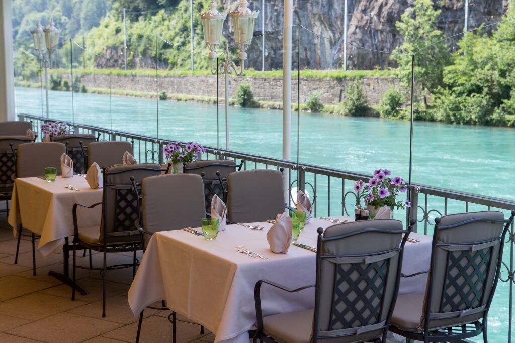 Scenic riverside dining with elegant tables