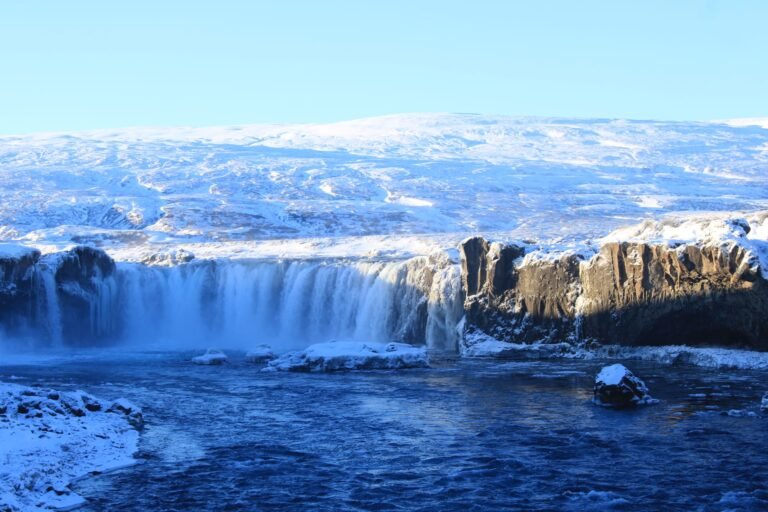Majestic waterfall in snowy landscape.