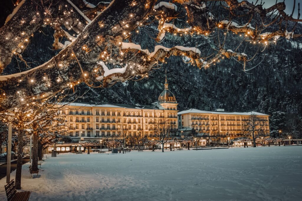 Snowy hotel illuminated by festive lights