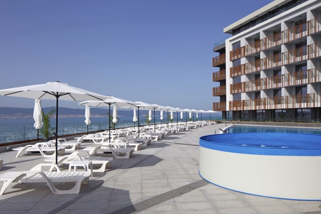 Paradiso Aparthotel pool area with sunbeds beachfront Sunny Beach Bulgaria